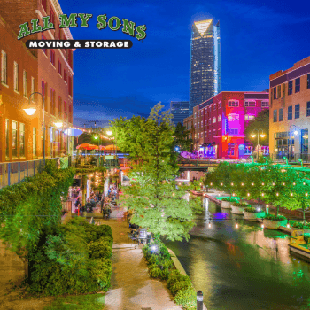 buildings and trees lit up along bricktown canal near midwest city, ok