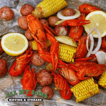 seafood boil with corn on the cob, potatoes, crawfish, and lemons