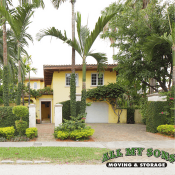 two story yellow house among palm trees in miami, florida